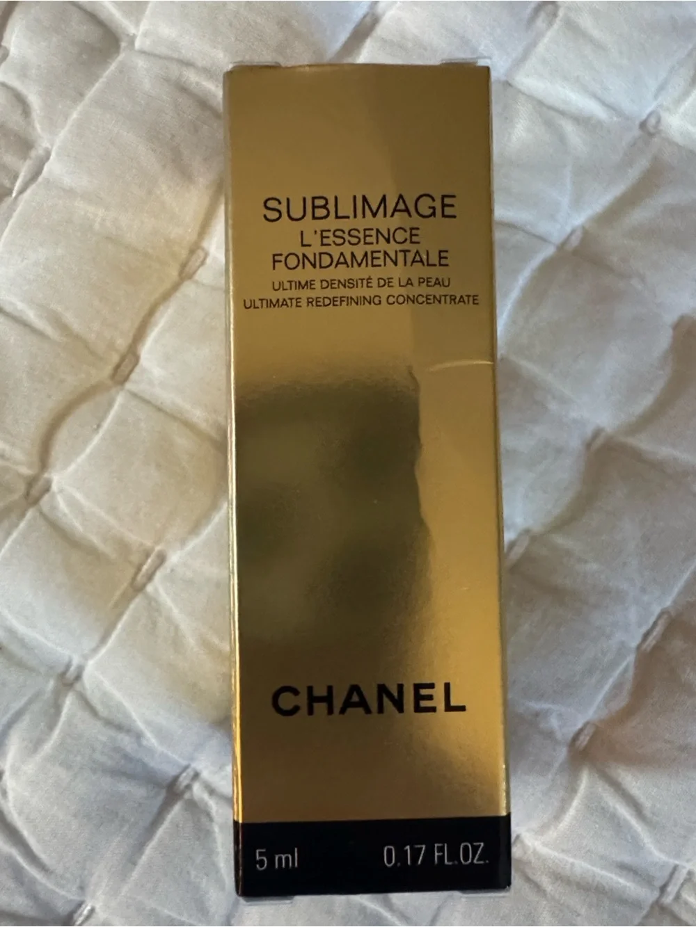 CHANEL Beauté Black and Cream Makeup Pouch and skincare products.